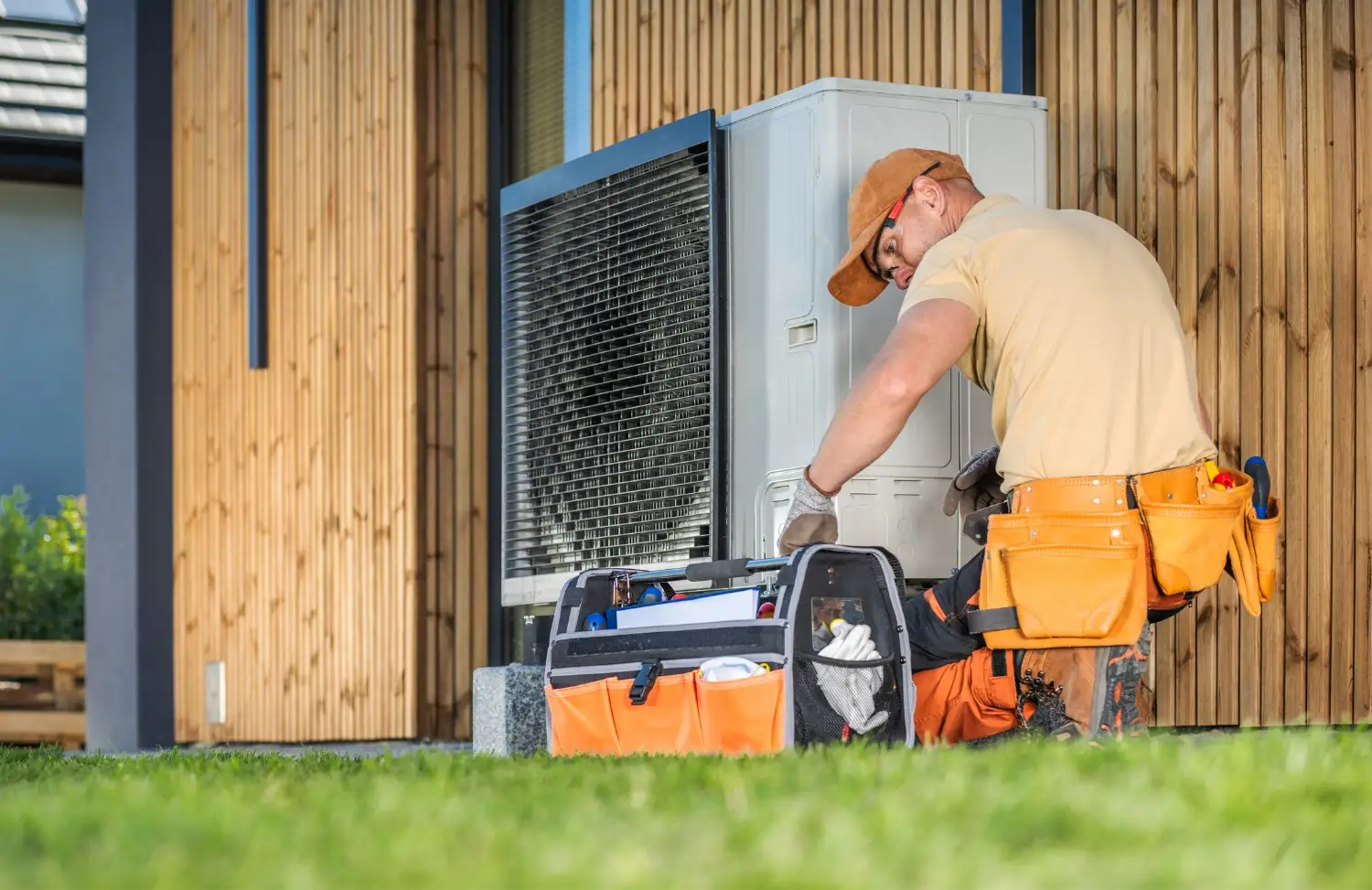 HVAC technician servicing outdoor heat pump.
